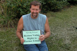 A man at a Restoration rally holds a sign reading: Sign the Petition - Restore Voting Rights to Former Felons The restoration of voting rights is on the line in Kentucky for felons who have paid their debt.